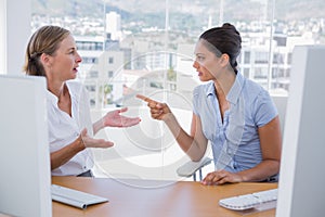 Businesswomen arguing at their desk