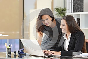 Businesswomen coworking with laptop at office photo