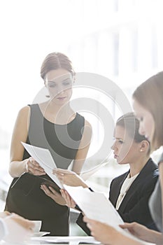 Businesswomen doing paperwork during coffee break