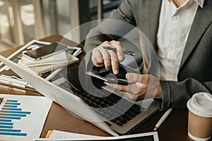 Businesswomen hand using smart phone, tablet payments online shopping, omni channel, digital tablet docking keyboard computer at