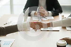 Businesswomen handshaking at group meeting, women power in busin