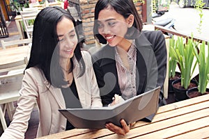 Businesswomen have a discussion at restaurant