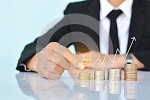 Businesswomen holding coin on blue background