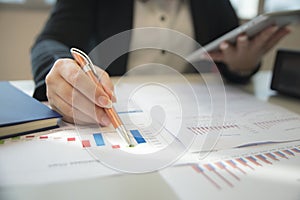 Businesswomen looking at business charts, graphs and documents background for analyzing the business