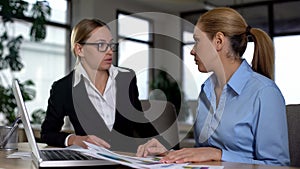 Businesswomen quarreling in office, boss disappointed with poor work of employee