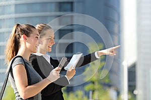 Businesswomen searching location with mobile gps and map