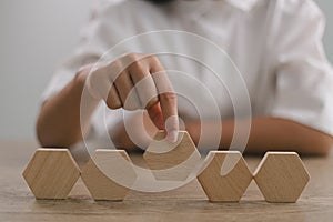 Businesswomen stack blank wooden cubes on the table with copy space, empty wooden cubes for input wording, and an infographic icon