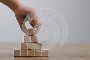 Businesswomen stack blank wooden cubes on the table with copy space, empty wooden cubes for input wording, and an infographic icon