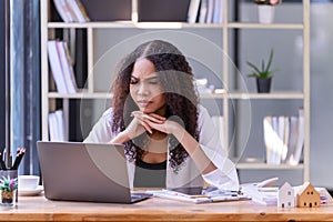 Businesswomen are stressed with work in front of a laptop and paper documents in the office