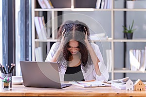 Businesswomen are stressed with work in front of a laptop and paper documents in the office