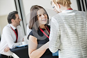 Businesswomen talking during coffee break at convention center photo