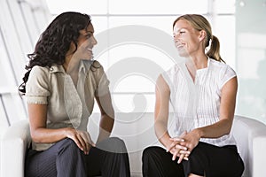 Businesswomen talking in lobby photo