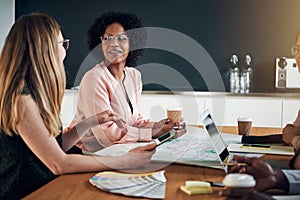 Businesswomen talking together during a meeting in an office boa