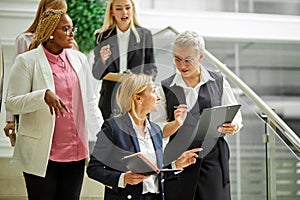 Businesswomen after training seminar, female business leader with co-workers