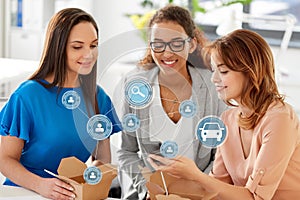 Businesswomen using car sharing app on smartphone