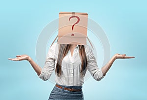 Businesswomen wearing carton box on her head with drawn red question mark.