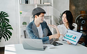 Businesswomen work and discuss their business plans. A Human employee explains and shows her colleague the results paper in modern