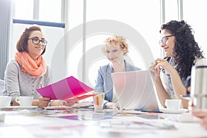 Businesswomen working at desk in creative office