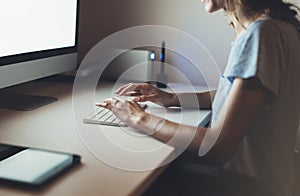 Businesswomen working at office with monitor computer, young hipster manager typing on keyboard, closeup finger female hands