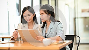 Businesswomen are working together on digital tablet computer