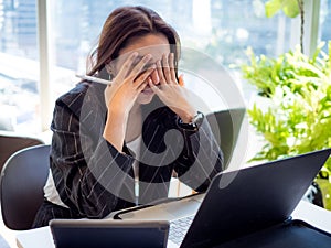 Businesswomen is working workplace office company.Female has symptom syndrome,sleepy,ill,sick,sad,headache,eyestrain face and pres