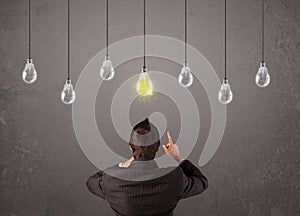 Businness guy in front of idea light bulbs concept