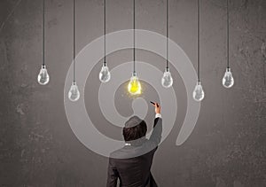 Businness guy in front of idea light bulbs concept