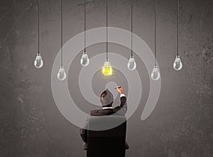 Businness guy in front of idea light bulbs concept