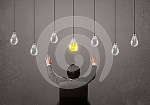Businness guy in front of idea light bulbs concept