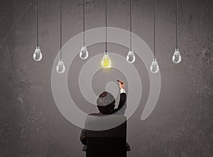 Businness guy in front of idea light bulbs concept