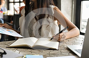 Businrss concept,Executive women are checking data from graphs and taking notes