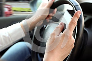 Businwssman using mobile smart phone while driving the car