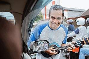 a busker approaches a car window when traffic is jammed photo