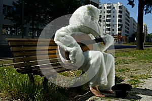 Busker Street Performer In Bear Suit Playing Guitar