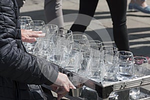 A busker, street performer, musician playing an unusual uncommon instrument made from wine glasses - glass harp photo