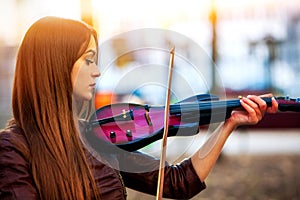 Busker woman perform music on violin park outdoor. Girl performing .