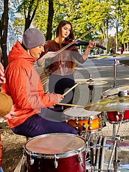 Buskers with girl violinist on autumn outdoor. photo