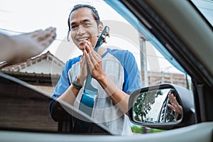 buskers with hand gestures ask for mercy when someone refuses photo