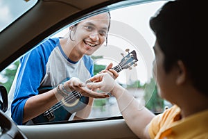 buskers receive by hand when someone gives coins from the car photo