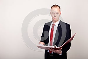 Busniessman posing with clipboard isolated on white background