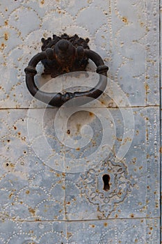 Vertical view. Knocker and lock of the main door of the San Lorenzo Martir Church, 16th century. Busot, Alicante, Spain photo