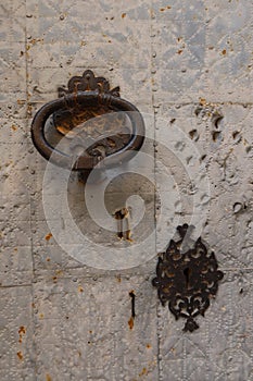 Vertical view. Knocker and lock of one of the doors of the San Lorenzo Martir Church, 16th century. Busot, Alicante, Spain photo