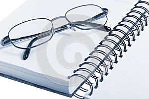 Bussines concept, glasses and notebook.