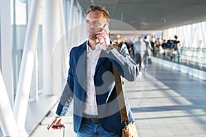 Man talking on phone in airport photo