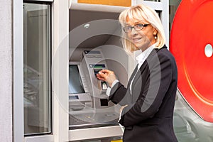 Bussines woman beside ATM photo