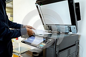 Bussiness man Hand press button on panel of printer, printer scanner laser