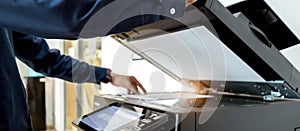 Bussiness man Hand press button on panel of printer, printer scanner laser office copy machine supplies start concept