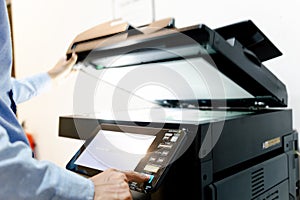 Bussiness man Hand press button on panel of printer, printer scanner laser in office copy machine supplies start concept