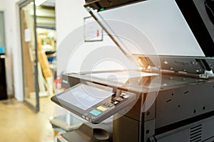 Bussiness man Hand press button on panel of printer, printer scanner laser photo