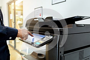 Bussiness man Hand press button on panel of printer, printer scanner